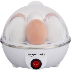Amazon Basics electric egg cooker with transparent lid, white compact design, red power switch and cooking tray for preparing boiled eggs at home.
