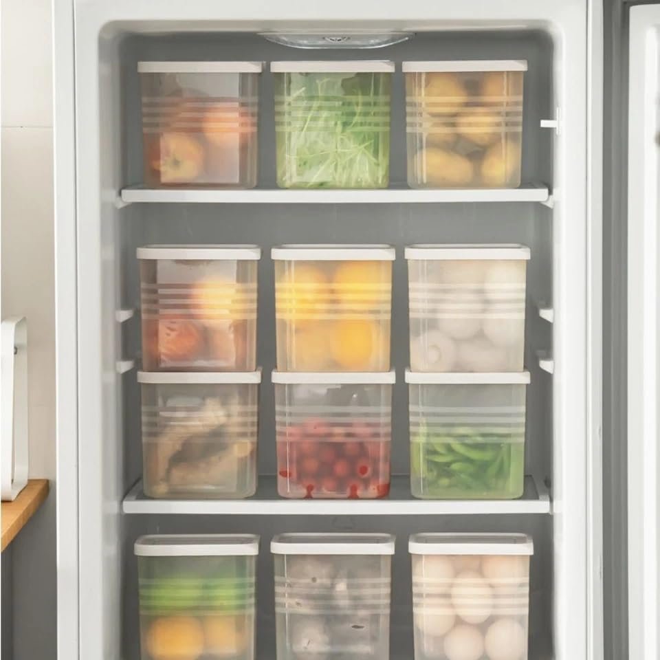 Transparent food storage containers organized in refrigerator