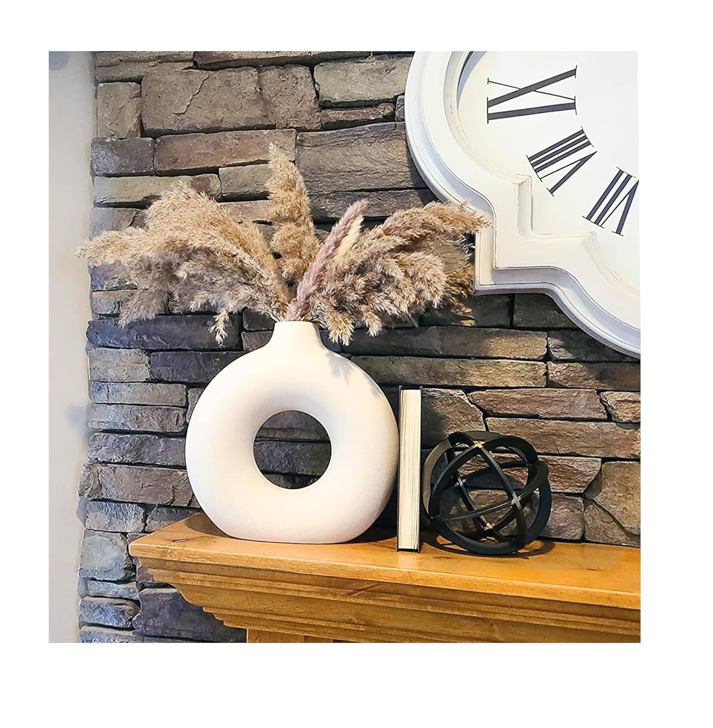 White ceramic decorative vase with dried pampas grass on a wooden shelf